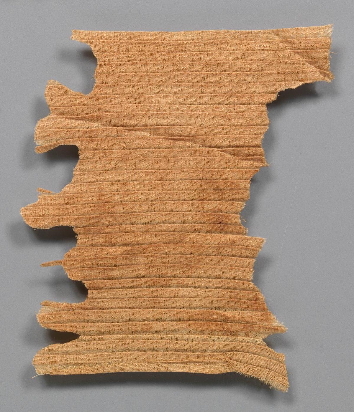 Pleated linen of Queen Neferu, Egypt, around 2050 BC — the fine, even pleats the lost method produced.
